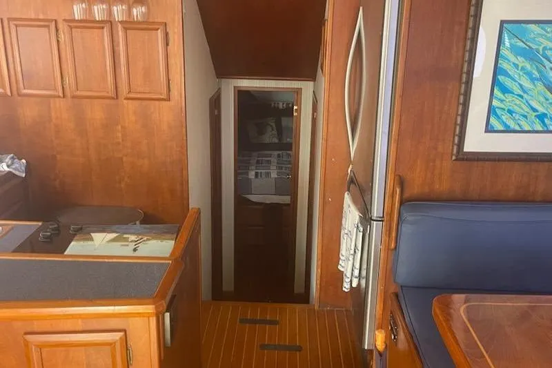 Slide: The Image of Interior of 1987 Topaz 44 Flybridge yacht with wood paneling and cozy cabin. - 7