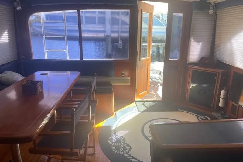 Slide: The Image of Interior of 1987 Topaz 44 Flybridge yacht with wooden table and nautical decor. - 8