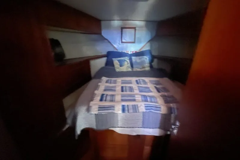 Slide: The Image of Cozy cabin interior of 1987 Topaz 44 Flybridge with bed and nautical decor. - 9