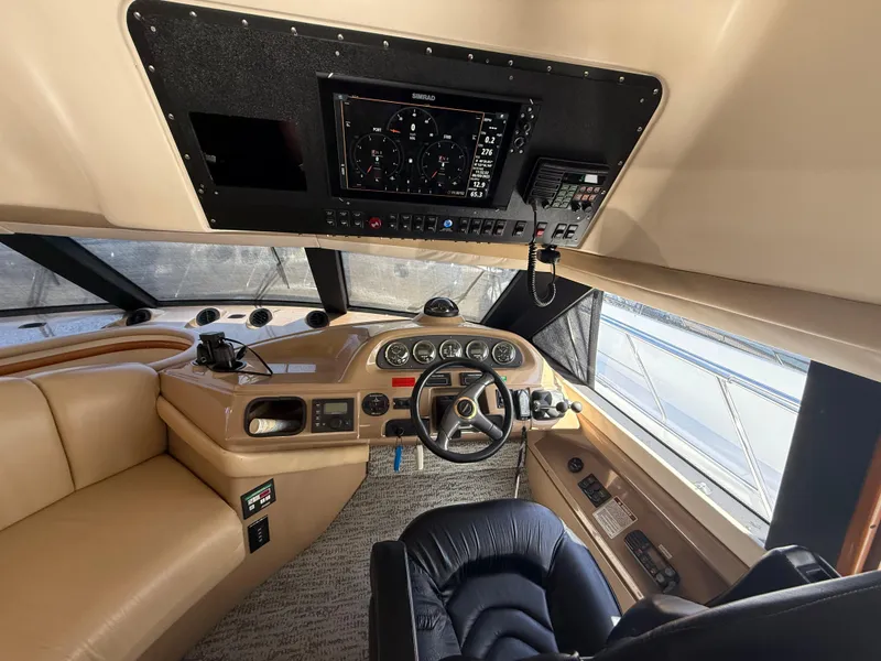 Slide: The Image of Interior of 2000 Carver 450 Voyager Pilothouse with steering wheel and navigation controls. - 10