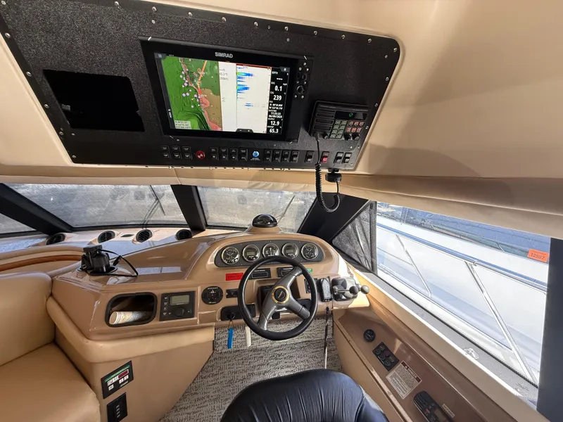 Slide: The Image of Pilothouse interior of 2000 Carver 450 Voyager with navigation equipment and steering wheel. - 11