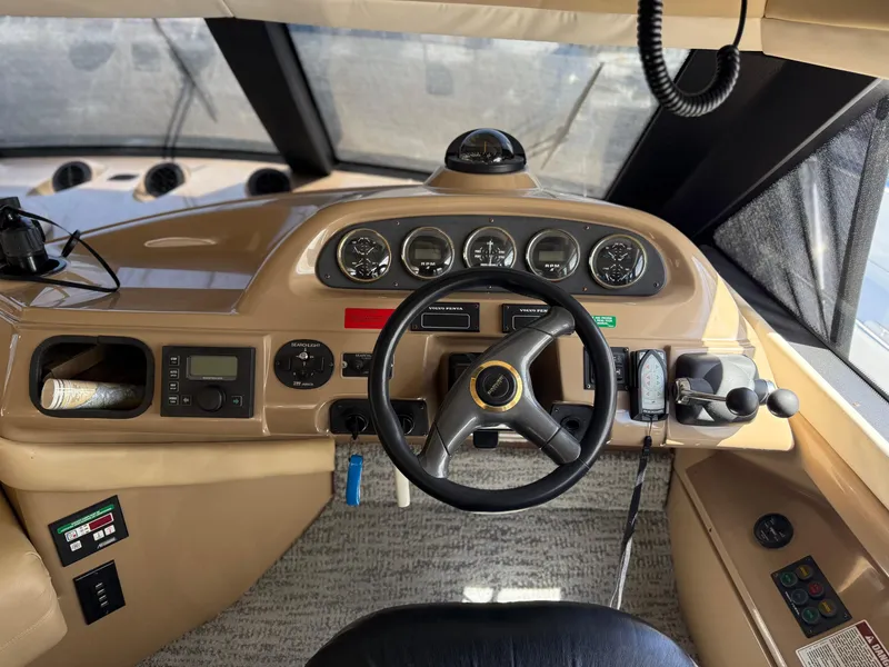 Slide: The Image of 2000 Carver 450 Voyager Pilothouse helm with steering wheel and instrument panel. - 12