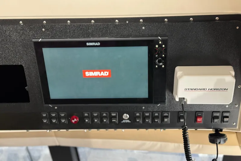 Slide: The Image of Control panel of 2000 Carver 450 Voyager Pilothouse with Simrad and Standard Horizon equipment. - 13