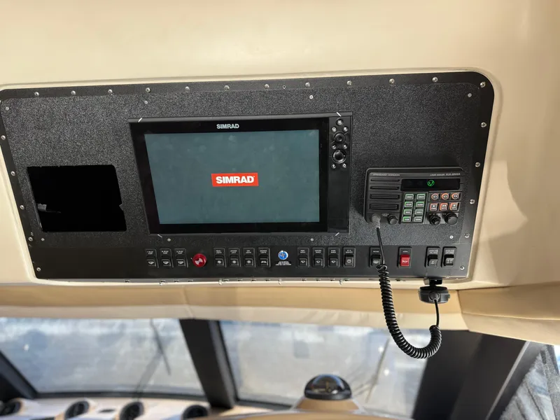 Slide: The Image of Control panel of a 2000 Carver 450 Voyager Pilothouse with Simrad navigation system. - 14