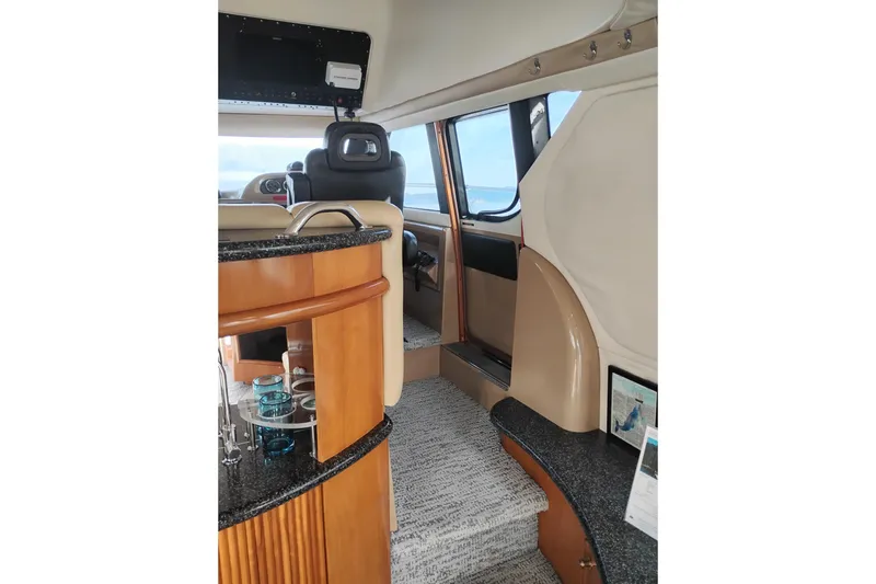 Slide: The Image of Interior of 2000 Carver 450 Voyager Pilothouse with luxurious seating and modern design. - 16