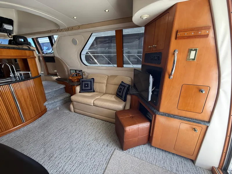 Slide: The Image of Luxurious interior of 2000 Carver 450 Voyager Pilothouse with leather seating and wood cabinetry. - 19