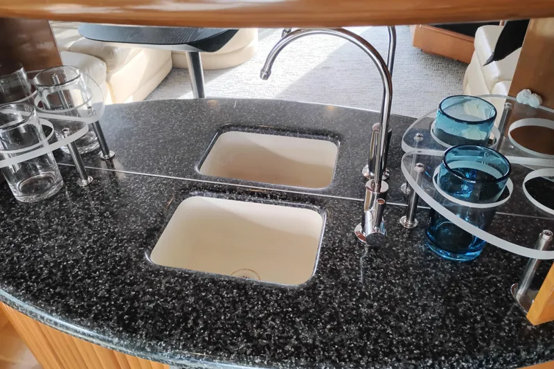 Slide: The Image of Luxurious kitchen area in 2000 Carver 450 Voyager Pilothouse with dual sinks and glass holders. - 20