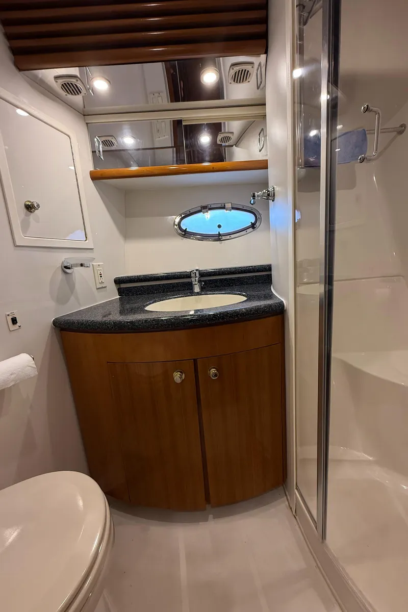 Slide: The Image of 2000 Carver 450 Voyager Pilothouse bathroom with sink, shower, and mirror. - 28
