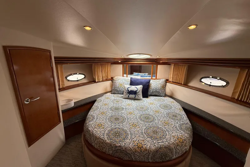 Slide: The Image of Luxurious bedroom in 2000 Carver 450 Voyager Pilothouse yacht with elegant bedding. - 29