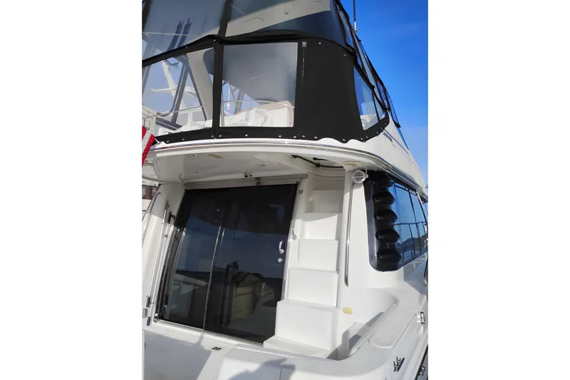 Slide: The Image of 2000 Carver 450 Voyager Pilothouse yacht with enclosed upper deck and sleek design. - 3