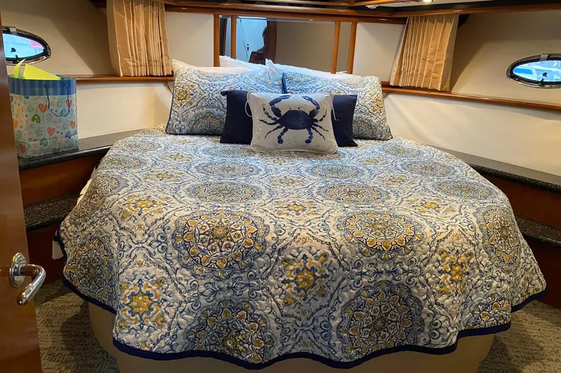 Slide: The Image of Luxurious bedroom in 2000 Carver 450 Voyager Pilothouse with patterned bedding and nautical decor. - 30