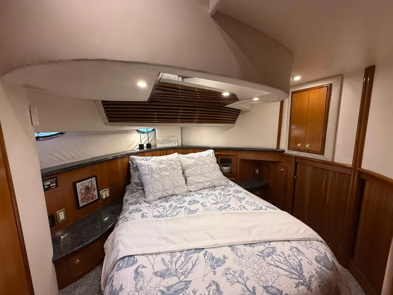 Slide: The Image of Luxurious bedroom interior of 2000 Carver 450 Voyager Pilothouse yacht with cozy bedding. - 32