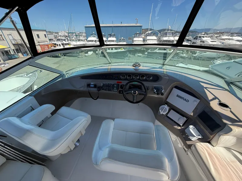 Slide: The Image of Pilothouse interior of 2000 Carver 450 Voyager with modern navigation equipment and marina view. - 33