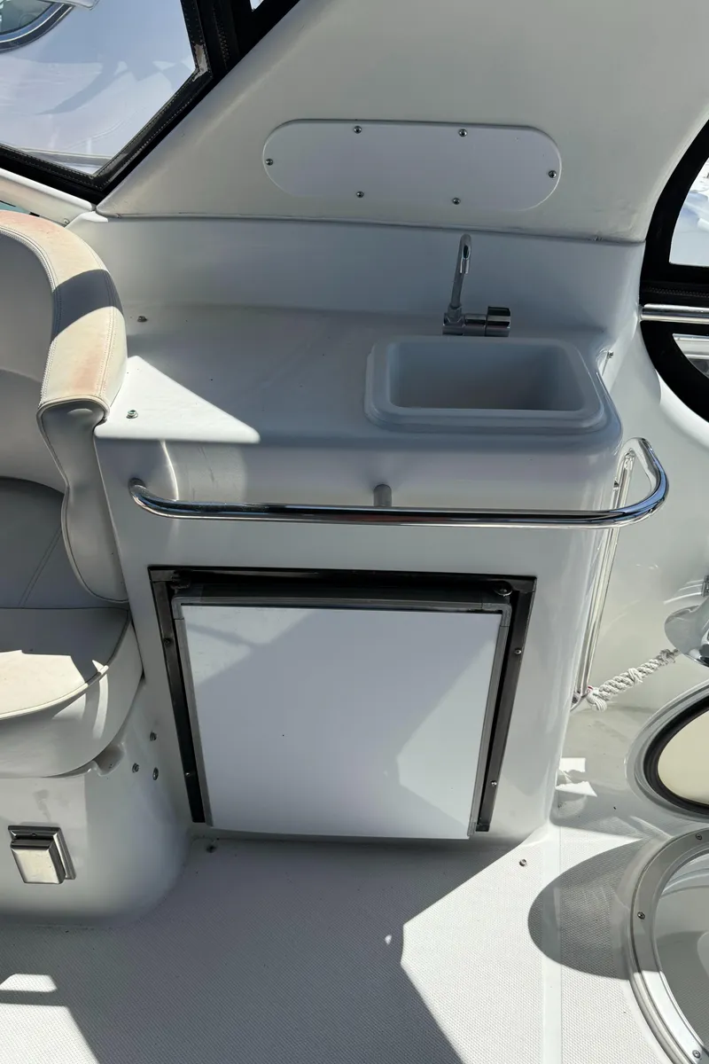 Slide: The Image of 2000 Carver 450 Voyager Pilothouse interior with sink and mini fridge. - 36