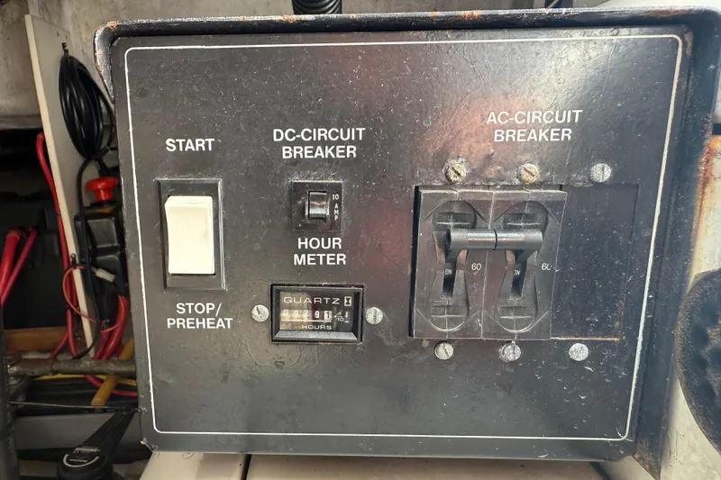 Slide: The Image of Control panel of a 2000 Carver 450 Voyager Pilothouse with circuit breakers and hour meter. - 40