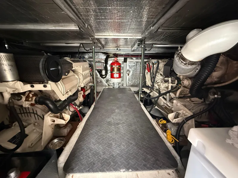 Slide: The Image of Engine room of a 2000 Carver 450 Voyager Pilothouse with visible machinery and fire extinguisher. - 41