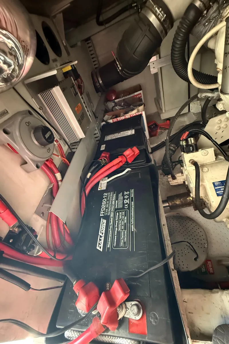 Slide: The Image of Engine room of 2000 Carver 450 Voyager Pilothouse with batteries and wiring. - 46