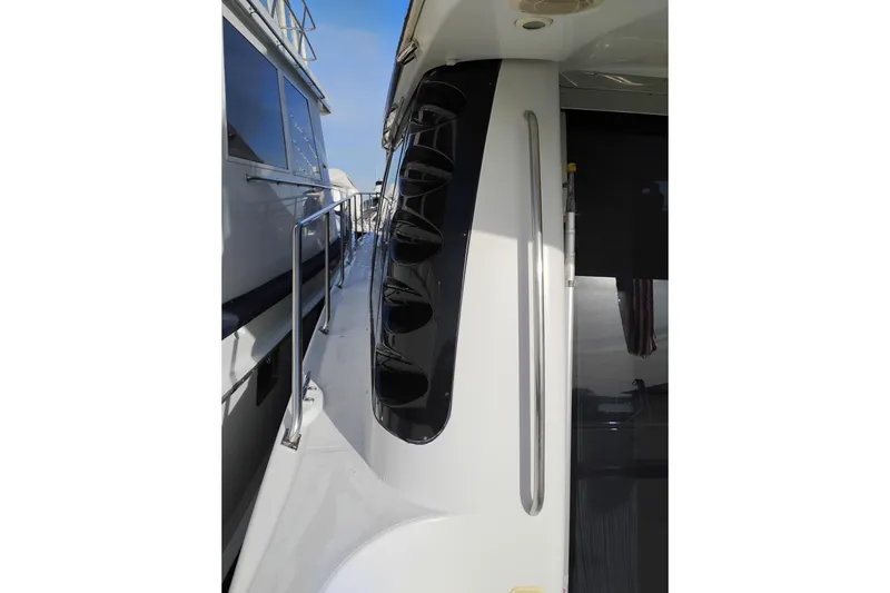Slide: The Image of Side view of 2000 Carver 450 Voyager Pilothouse yacht with railing and windows. - 53