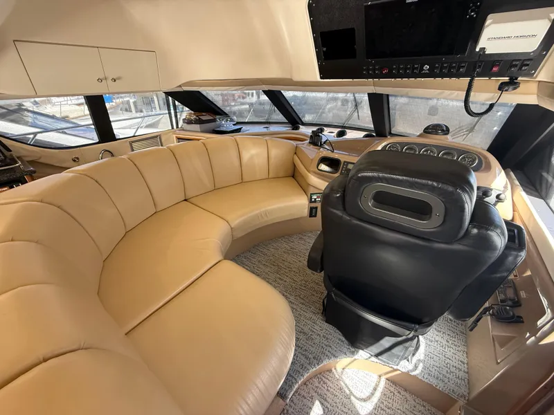 Slide: The Image of Luxurious interior of 2000 Carver 450 Voyager Pilothouse with leather seating and helm. - 9