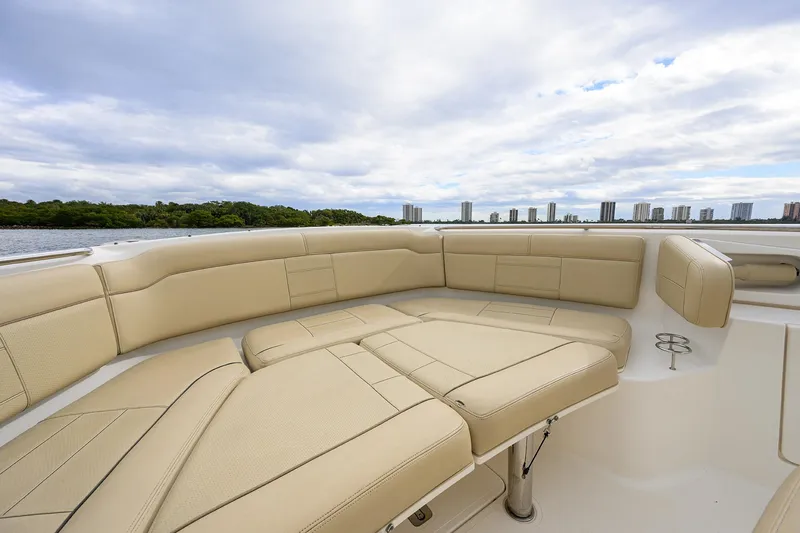 Slide: The Image of Luxurious seating on 2019 Pursuit S 328 Sport boat with city skyline view. - 11