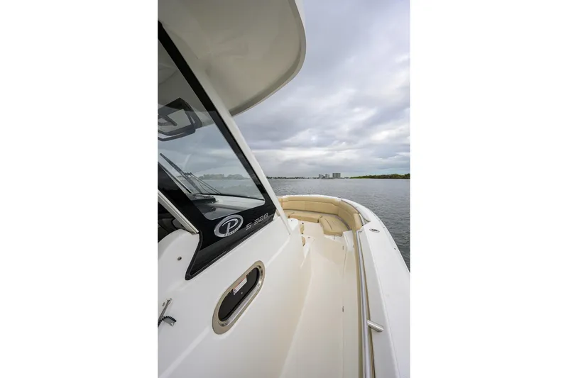 Slide: The Image of 2019 Pursuit S 328 Sport boat on calm water under cloudy sky. - 16