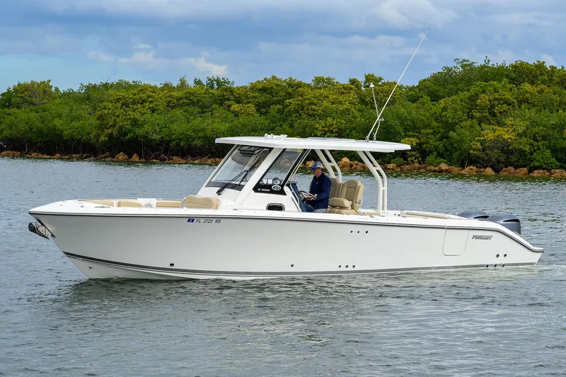 Slide: The Image of 2019 Pursuit S 328 Sport boat cruising on a calm waterway. - 19