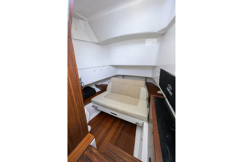 Slide: The Image of 2019 Pursuit S 328 Sport cabin interior with wooden flooring and cushioned seating. - 29