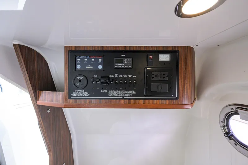 Slide: The Image of 2019 Pursuit S 328 Sport control panel with wood finish and modern switches. - 33