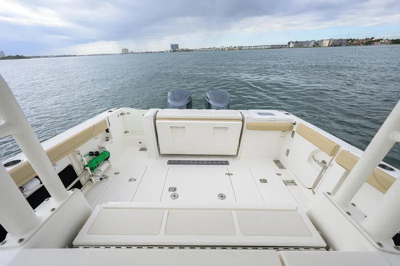 Slide: The Image of 2019 Pursuit S 328 Sport boat deck with ocean view and dual engines. - 35