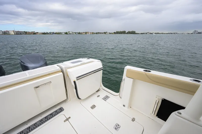 Slide: The Image of 2019 Pursuit S 328 Sport boat deck overlooking calm waters and distant shoreline. - 43