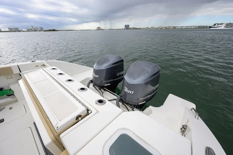 Slide: The Image of 2019 Pursuit S 328 Sport boat with twin Yamaha 300 engines on open water. - 46