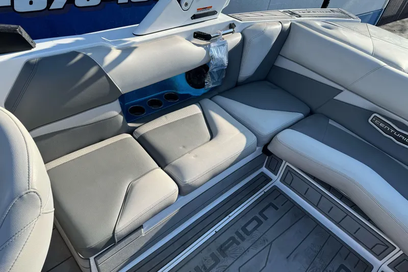 Slide: The Image of 2021 Centurion Fi23 boat interior with gray seating and cup holders. - 10