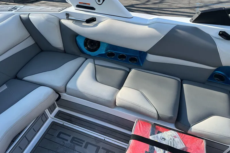 Slide: The Image of 2021 Centurion Fi23 boat interior with gray seating and speaker system. - 11