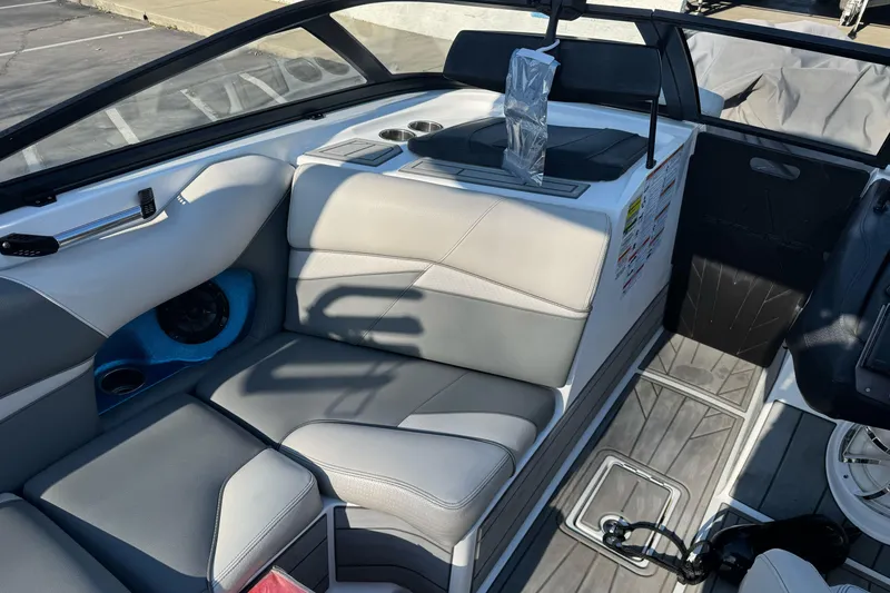 Slide: The Image of 2021 Centurion Fi23 boat interior with gray seating and cup holders. - 12