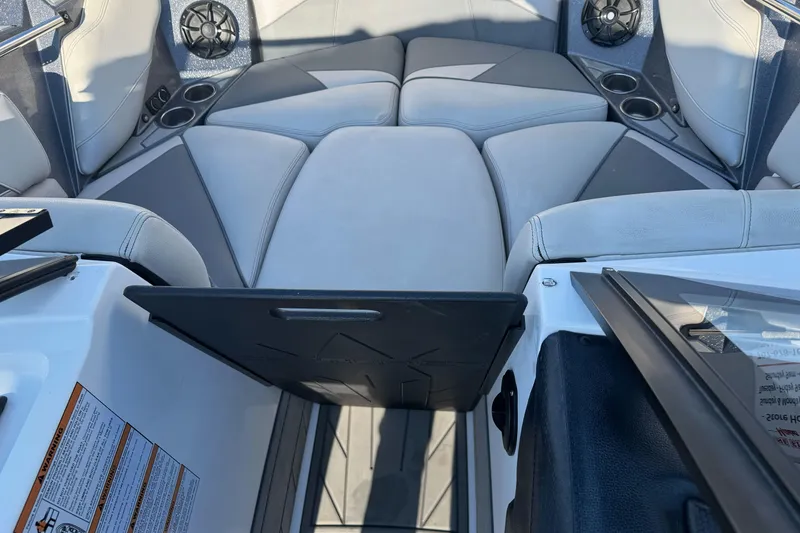 Slide: The Image of 2021 Centurion Fi23 boat interior with cushioned seating and cup holders. - 20