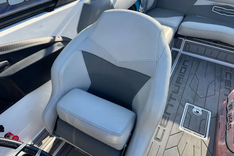 Slide: The Image of 2021 Centurion Fi23 boat interior with gray seating and branded flooring. - 21