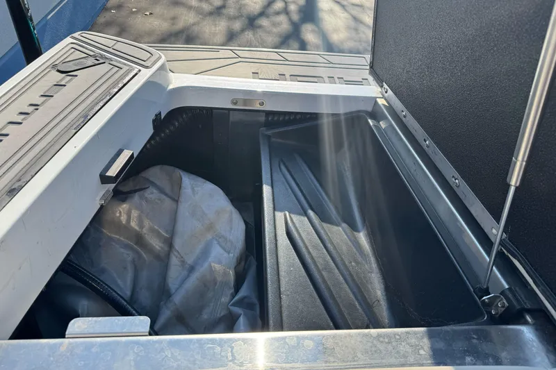 Slide: The Image of Open storage compartment in 2021 Centurion Fi23 boat, showing interior details. - 26