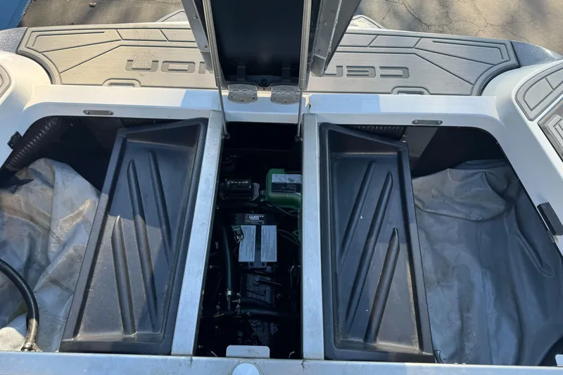 Slide: The Image of 2021 Centurion Fi23 boat engine compartment with open hatches and visible components. - 27