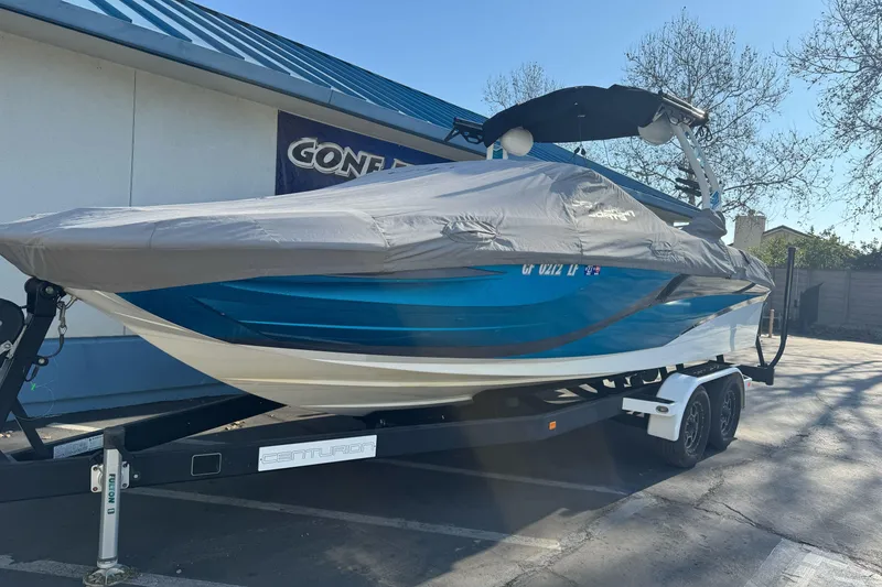 Slide: The Image of 2021 Centurion Fi23 boat on trailer, covered, parked outdoors. - 3