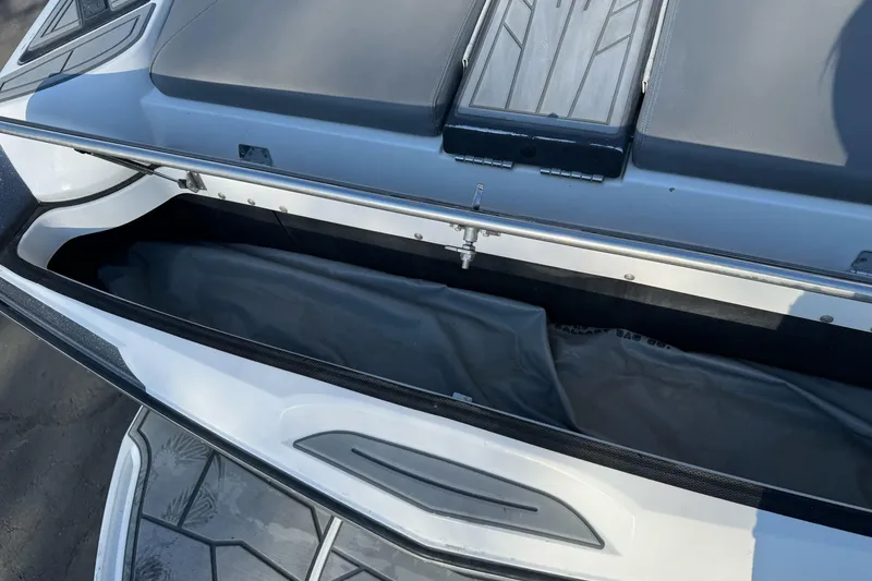 Slide: The Image of 2021 Centurion Fi23 boat storage compartment with open lid, showcasing interior space. - 30