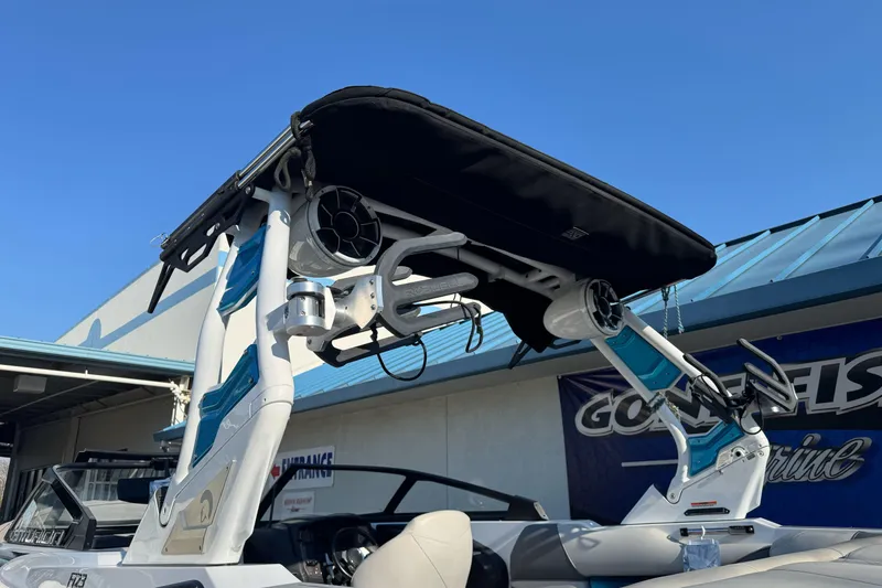 Slide: The Image of 2021 Centurion Fi23 boat with wakeboard tower and speakers under clear blue sky. - 31