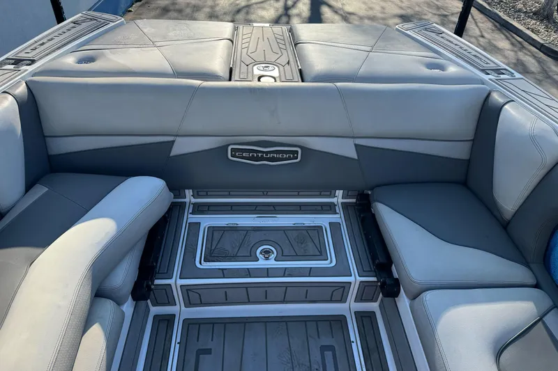 Slide: The Image of 2021 Centurion Fi23 boat interior with gray seating and branded logo. - 9