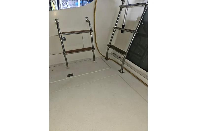 Slide: The Image of 1989 Tollycraft Sport Sedan interior with metal and wood ladder. - 31