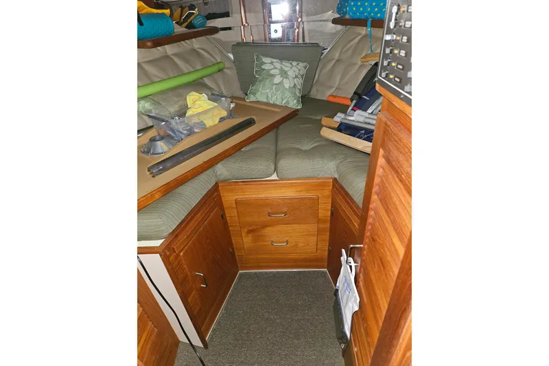 Slide: The Image of 1989 Tollycraft Sport Sedan interior with leather seating and wooden table. - 18