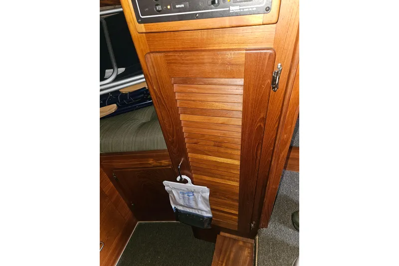 Slide: The Image of 1989 Tollycraft Sport Sedan interior with leather seating and wooden storage drawers. - 19