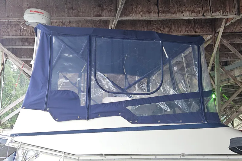 Slide: The Image of 1989 Tollycraft Sport Sedan boat docked in a covered marina. - 2