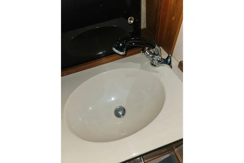 Slide: The Image of 1989 Tollycraft Sport Sedan interior with wooden cabinetry and seating area. - 22