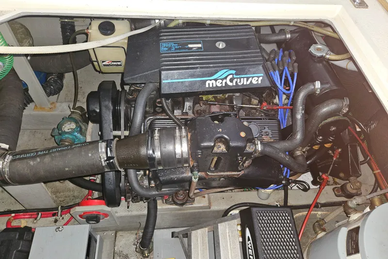 Slide: The Image of 1989 Tollycraft Sport Sedan bathroom sink with chrome faucet and wooden accents. - 24