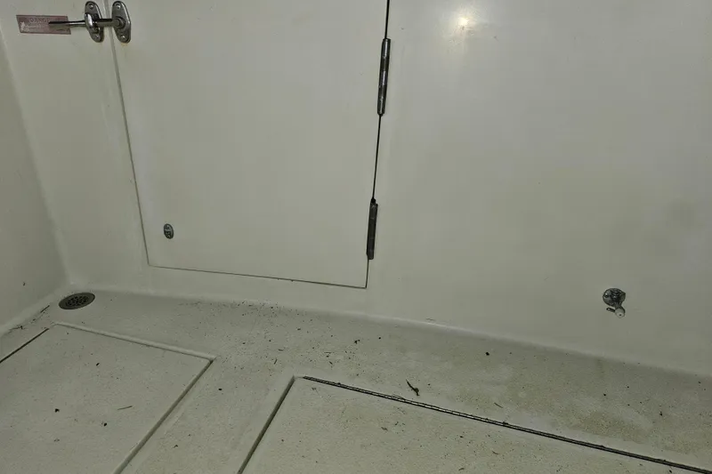 Slide: The Image of 1989 Tollycraft Sport Sedan deck with storage hatch and blue bucket. - 30