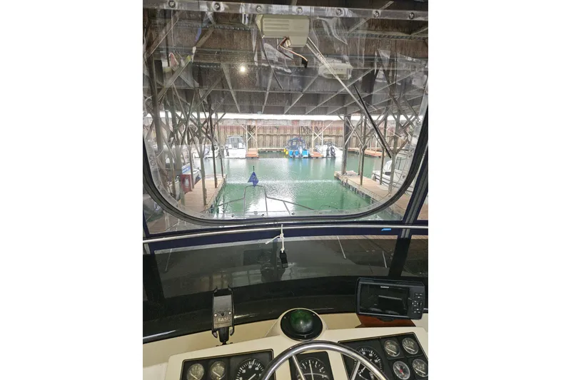 Slide: The Image of 1989 Tollycraft Sport Sedan helm with dual seats and navigation equipment. - 5